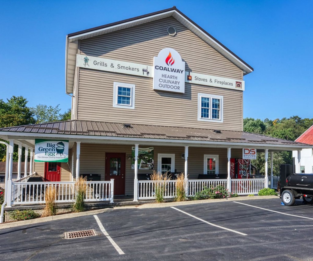 Exterior view of Coalway of Charm store with porch and signage.