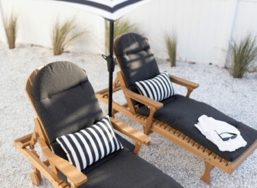 Comfo Back Chaise Lounges in Natural Teak. Cushions in Heritage Char. Pillowsin Regatta Ebony